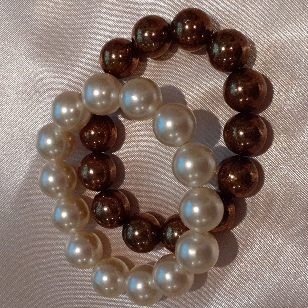 2 faux Pearl bracelets  one cream, the other copper colored.